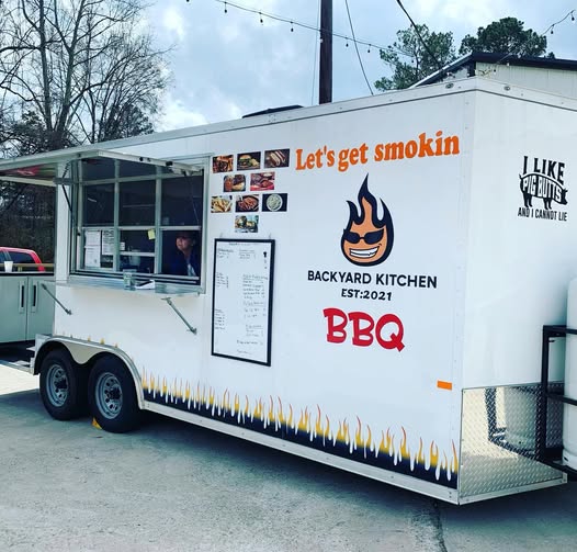 Food truck with serving window and menu at The Dallas Markets