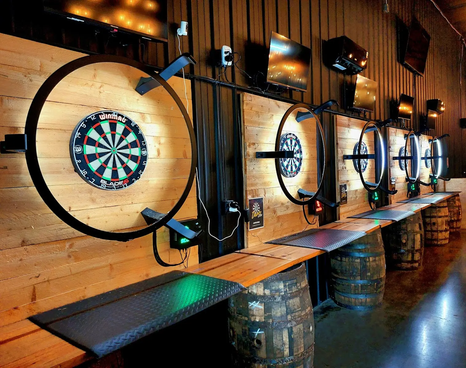 Electronic steel-tip dart stations in the event room