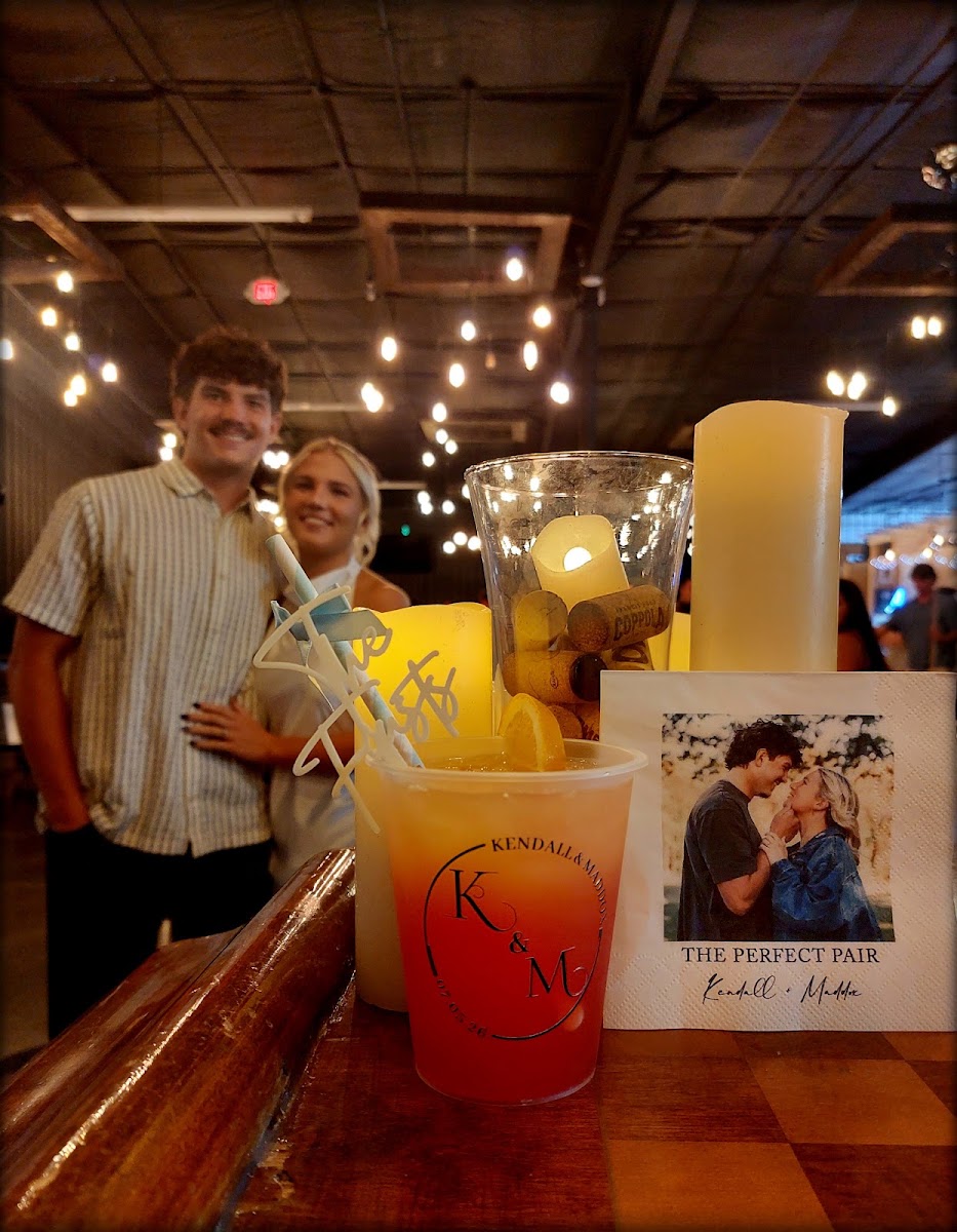 An engaged couple celebrating with guests at The Dallas Markets event venue